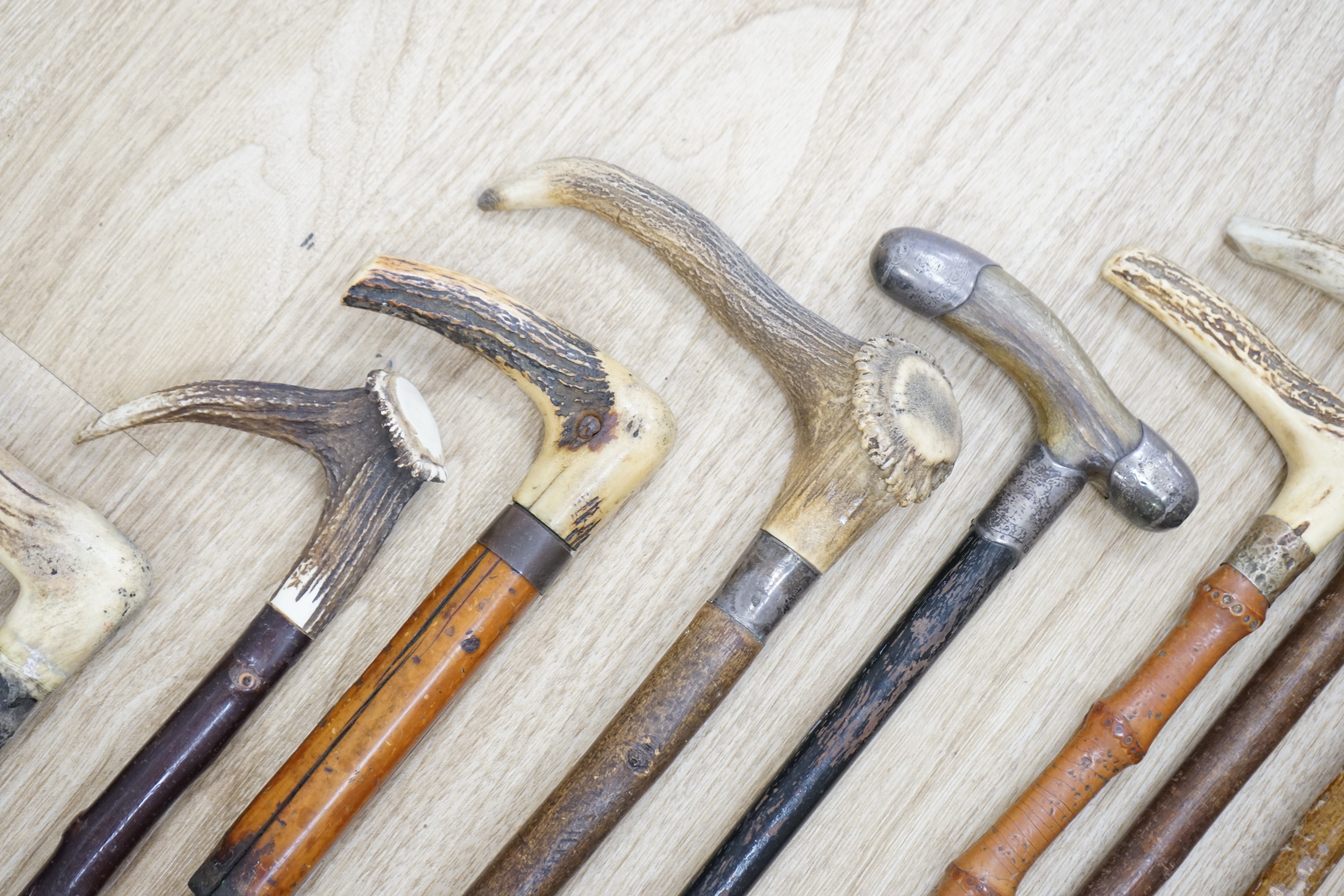 Twelve assorted walking sticks including silver mounted and staghorn handled